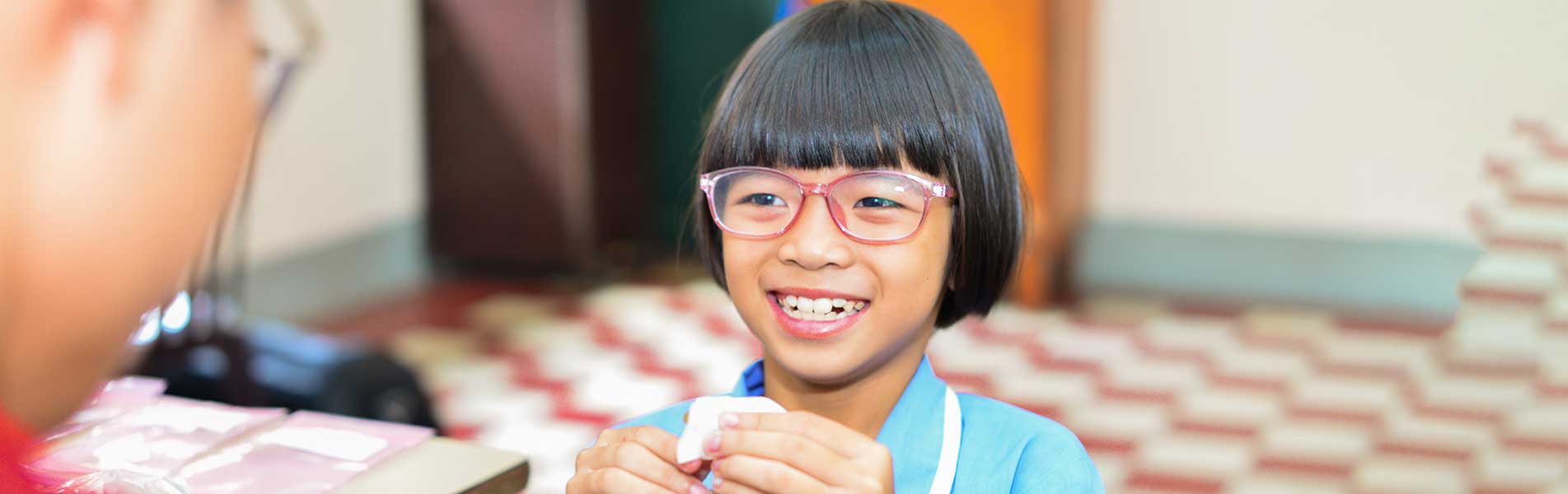 happy girl with a hearing aid