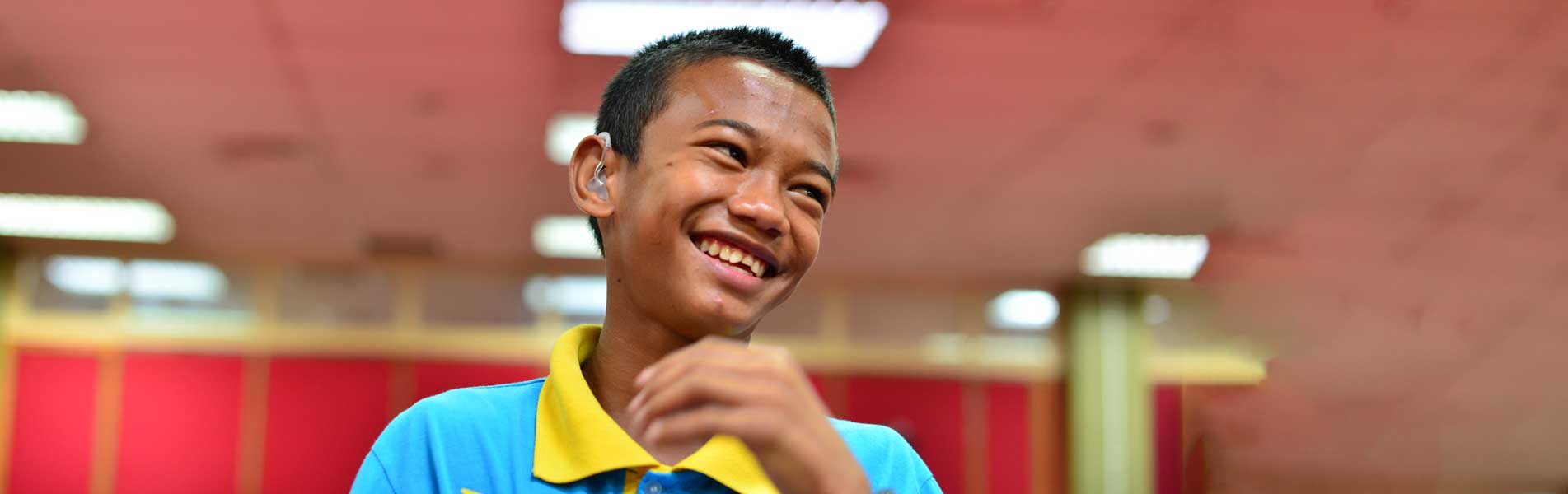 young man happy to have hearing aid