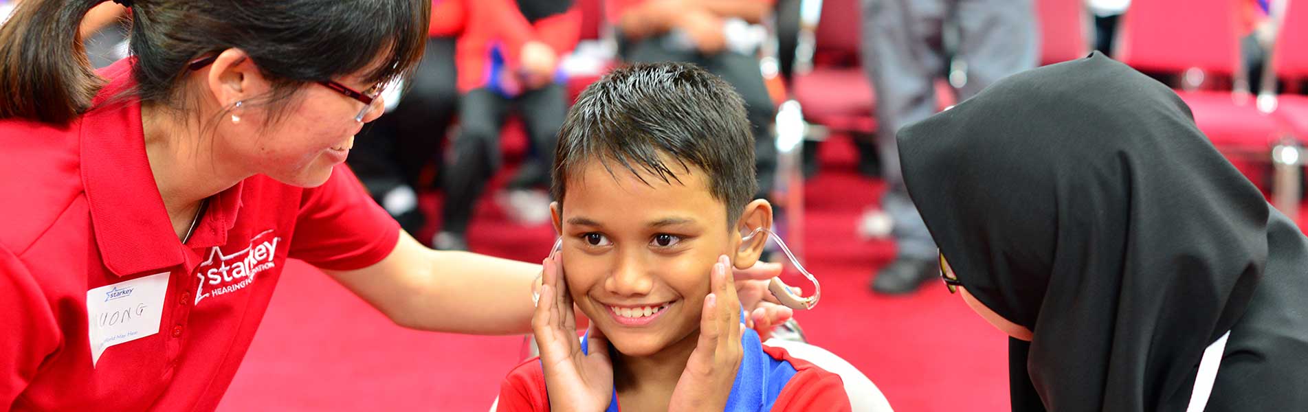 happy boy with hearing aid