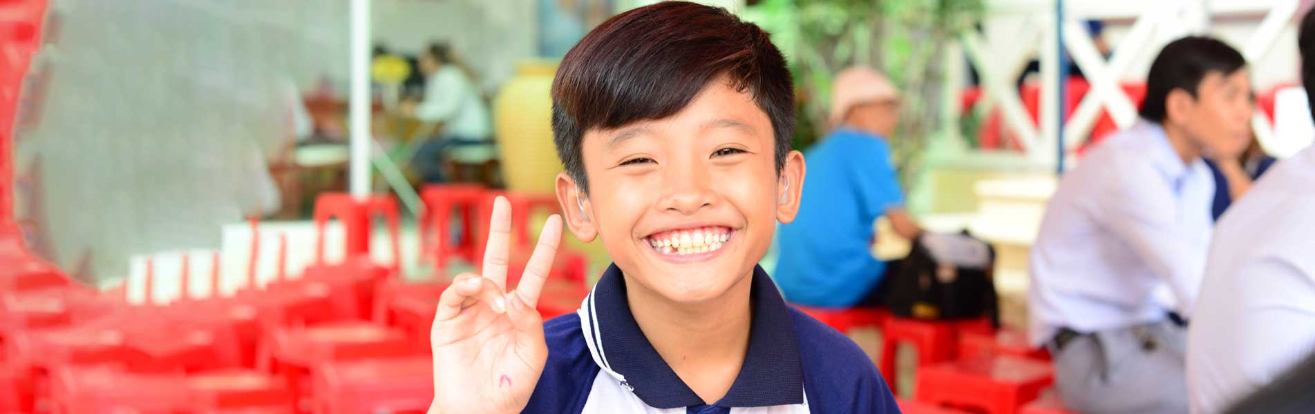 happy boy with hearing aid