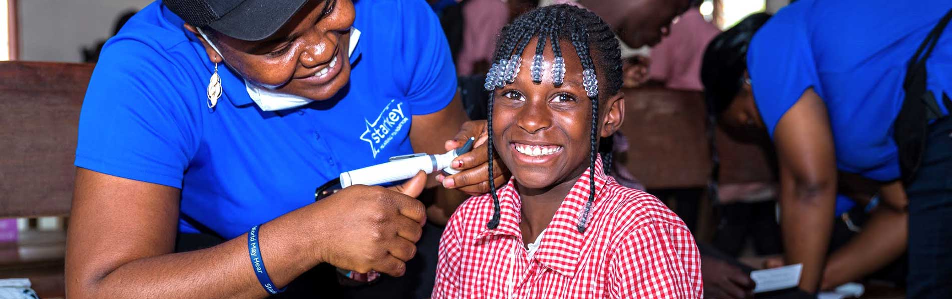 Young girl smiling to get hearing aid