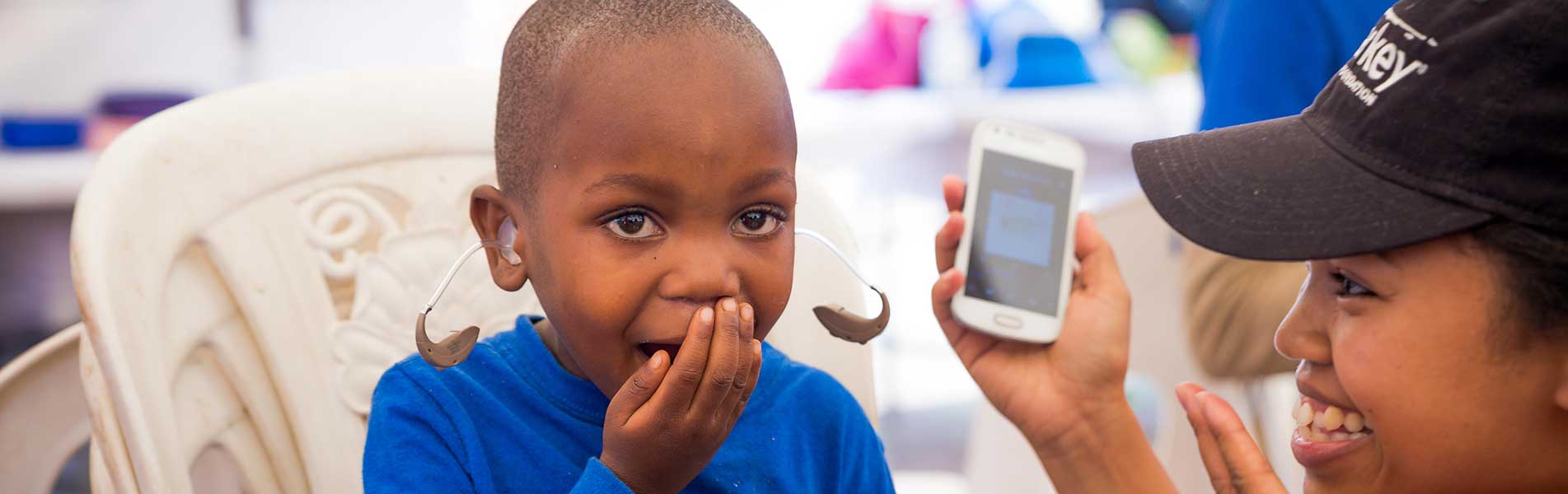 happy boy with hearing aid