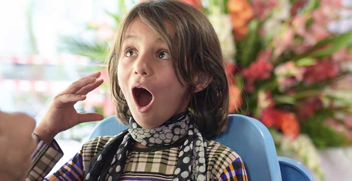 girl in Afghanistan very excited to have hearing aids