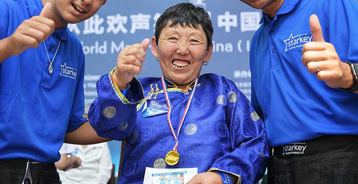 happy woman with a hearing aid