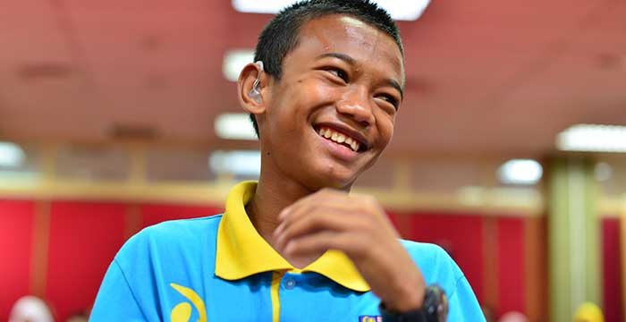 young man happy to have hearing aid