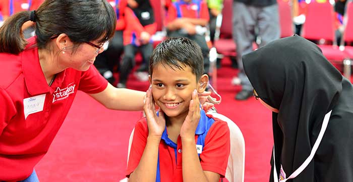 happy boy with hearing aid