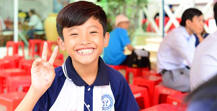 happy boy with hearing aid