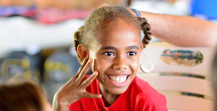 happy girl with a hearing aid