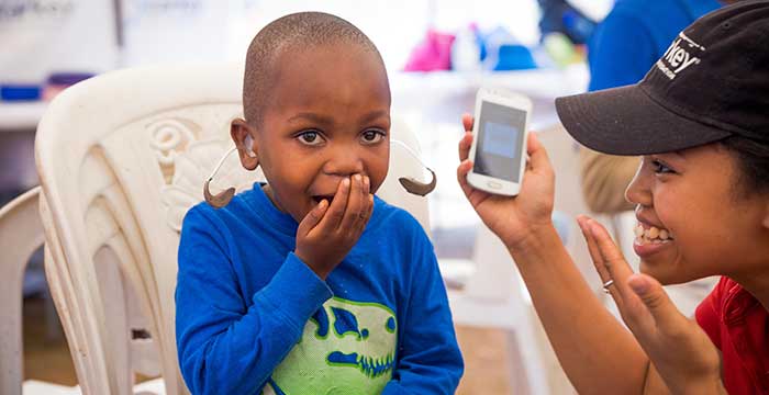 happy boy with hearing aid