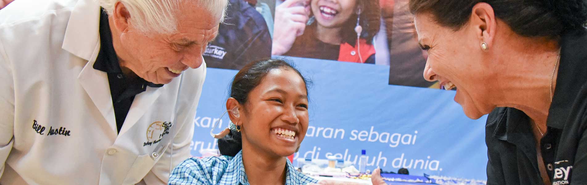 Bill and Tani with a hearing aid participant