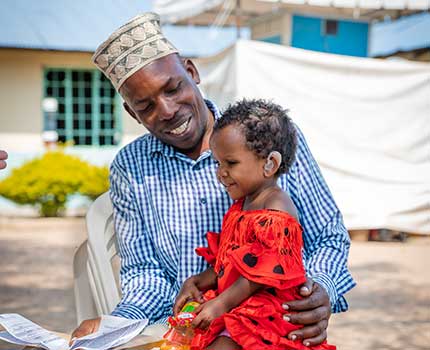 father with his little girl that now has hearing aids